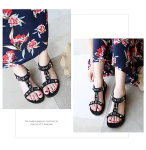 Detail of black T-strap sandals with bohemian colorful beads and rhinestone accents