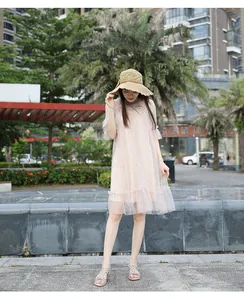 Pink bohemian dress with star-patterned mesh layers and elegant ruffled hem details