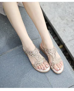 Detail of champagne gold flat sandals with crystal rhinestones and elastic heel strap