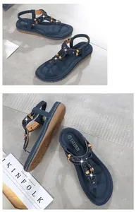 Detail view of blue wedge sandals with rhinestones, beaded T-strap, and non-slip rubber sole