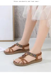 Detail of brown T-strap flat sandals with ethnic woven braids and colorful bead decor