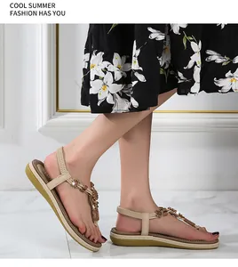 Detail of bohemian flat sandals with floral beads and elastic heel strap on model