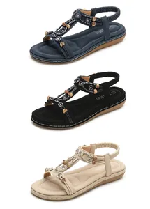 Three colors of women's flat sandals with floral diamond accents and T-strap design