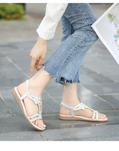 Silver boho flat sandals featuring rhinestone flower details and elastic back straps