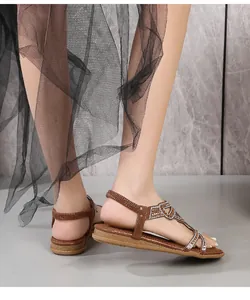 Side view of brown bohemian flat sandals with sparkling rhinestones and elastic heel strap
