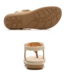 Detail of bohemian flat sandals with rhinestone accents and non-slip rubber sole