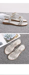 Detail of bohemian flat sandals with silver flower rhinestones and elastic heel strap