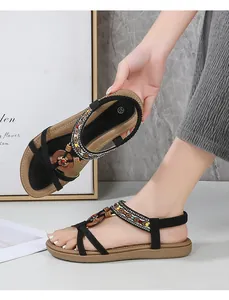 Close-up of ethnic flat sandals with colorful beads and wooden pendants detail