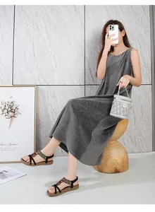 Detail of dark grey pleated maxi dress with ethnic style beaded lace-up sandals