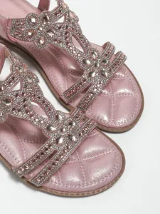Close-up of pink Bohemian flat sandals featuring intricate floral rhinestone beadwork