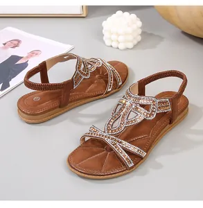 Detail of brown suede sandals featuring bohemian rhinestones and elastic heel strap