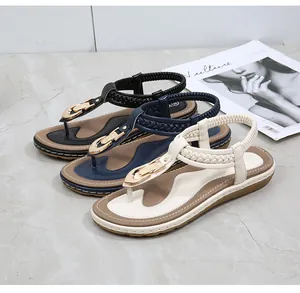 Flat thong sandals with gold buckles and woven straps in black, blue, and cream colors
