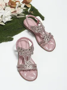Detail of pink bohemian flat sandals with sparkling silver rhinestones and flower beadwork