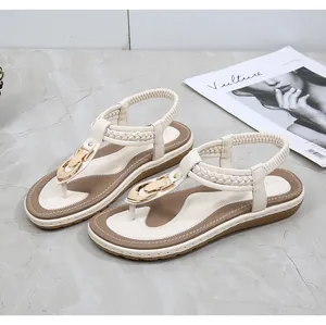 Detail of cream T-strap toe-loop sandal with gold buckle and braided texture strap