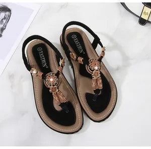 Detailed view of bohemian sandals with ethnic beads, rhinestones and elastic heel strap