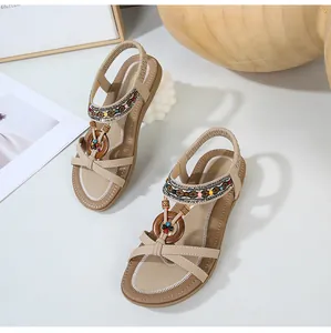 Detail of bohemian flat sandals with colorful beads and wooden ring ornaments