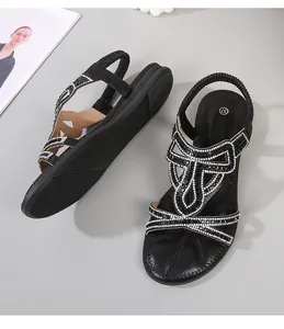Detail of black bohemian wedge sandals with sparkling rhinestones and elastic heel strap