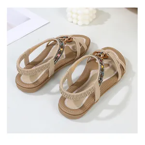 Detail view of bohemian flat sandals with colorful ethnic beads and braided straps