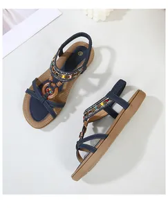 Detail view of navy bohemian sandals with ethnic woven straps and colorful bead accents