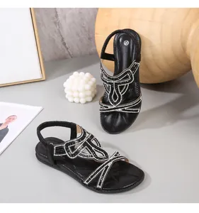 Detail of black rhinestone flat sandals with elastic heel strap and size 37 mark