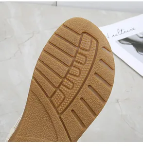 Macro detail of tan rubber outsole with non-slip groove texture for flip-flop sandals