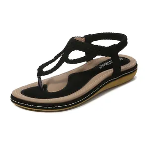 Sandales minimalistes noires à entre-doigt pour femme avec bride tressée et talon plat