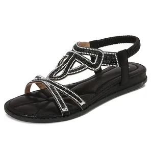 Women's black flat T-strap sandals with rhinestone embellishments and elastic heel strap