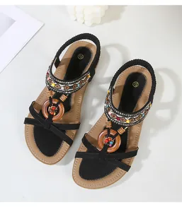 Detailed top view of bohemian flat sandals with ethnic beads and wooden ring decor