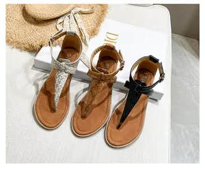 Three pairs of T-strap flat sandals with snake pattern in white, brown, and black