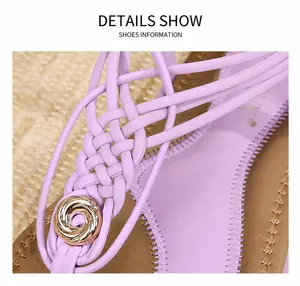 Détail de sandales plates bohèmes avec brides croisées tressées en cuir PU violet