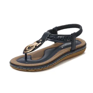 Women's flat thong sandals in navy blue with gold buckle and braided strap detail