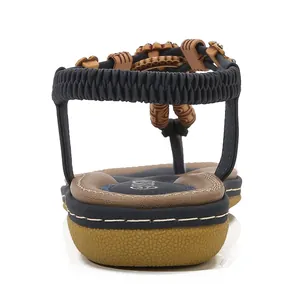 Women's Bohemian flat sandals with navy elastic straps and beaded details, rear view
