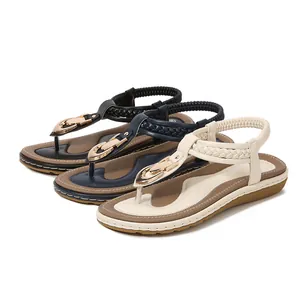 Flat T-strap sandals for women with gold horseshoe buckle in black, blue and white colors