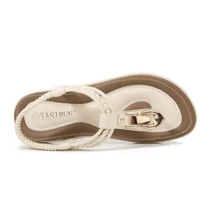Cream white flat thong sandals with gold U-shaped buckle and woven straps for summer wear