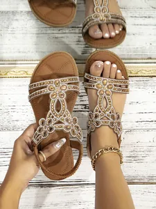 Close-up of Bohemian flat sandals featuring rhinestones and elastic heel straps