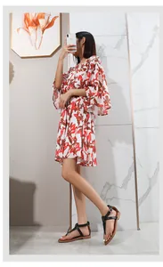 Detail of T-strap flat sandals paired with red leaf print dress for summer fashion