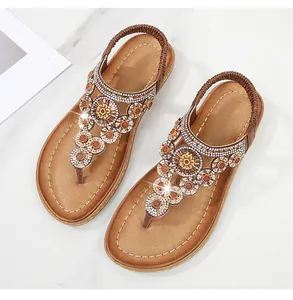 Detailansicht der braunen Bohème-Sandalen mit funkelnden Kristallperlen und floralem Muster