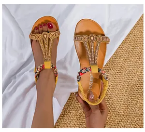 Detailansicht gelber Boho-Sandalen mit aufwendiger Blumenstickerei und glänzenden Perlen