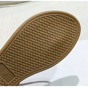 Close-up of brown rubber sole with woven texture and size 37 mark on Roman sandal