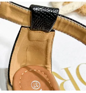 Close-up of bohemian Roman sandals showing black snake skin straps and 37 size print