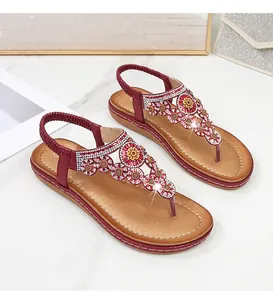 Detail von Boho-Sandalen mit Strass-Blumen und dekorativer Perlenstickerei am Riemen