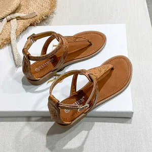 Detail of brown faux snake texture flip-flop sandals with ankle strap and buckle