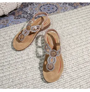 Detailed top view of bohemian thong sandals with rhinestone flower beading and elastic strap