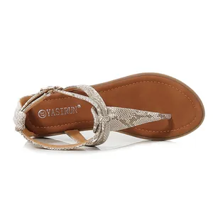 Close-up of women's flat T-strap sandals with snake print pattern and non-slip sole