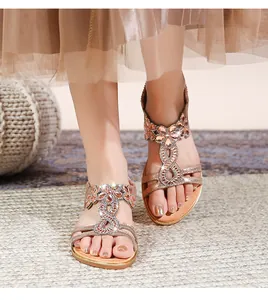 Detailaufnahme von Boho-Sandalen mit aufwendigen Strass-Blumenmustern in elegantem Champagner-Gold