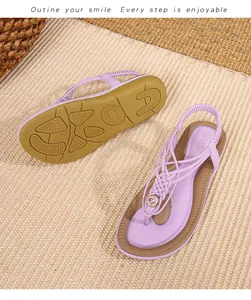Détail de sandales bohèmes mauves avec lanières tressées et ornements floraux dorés