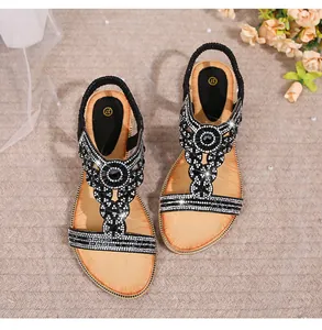 Detailed view of bohemian flat sandals featuring sparkling rhinestones and elastic heel strap