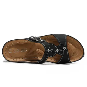 Detailansicht schwarzer Strass-Sandalen mit weißer Kontrastnaht und Metallschnalle