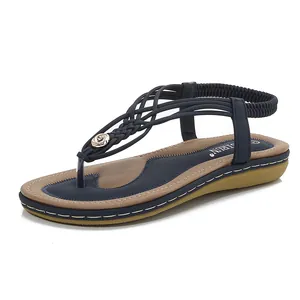 Sandales bohèmes bleu marine avec brides tressées, détail doré et semelle compensée