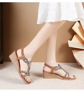Detail of bohemian rhinestone sandals with brown wedge heels and elastic back straps